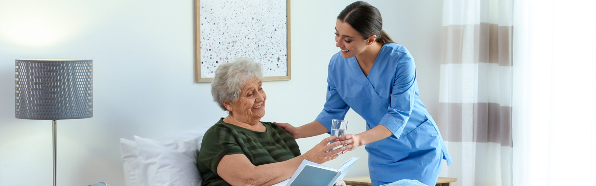 Female Caregiver served a glass of water of the elder woman