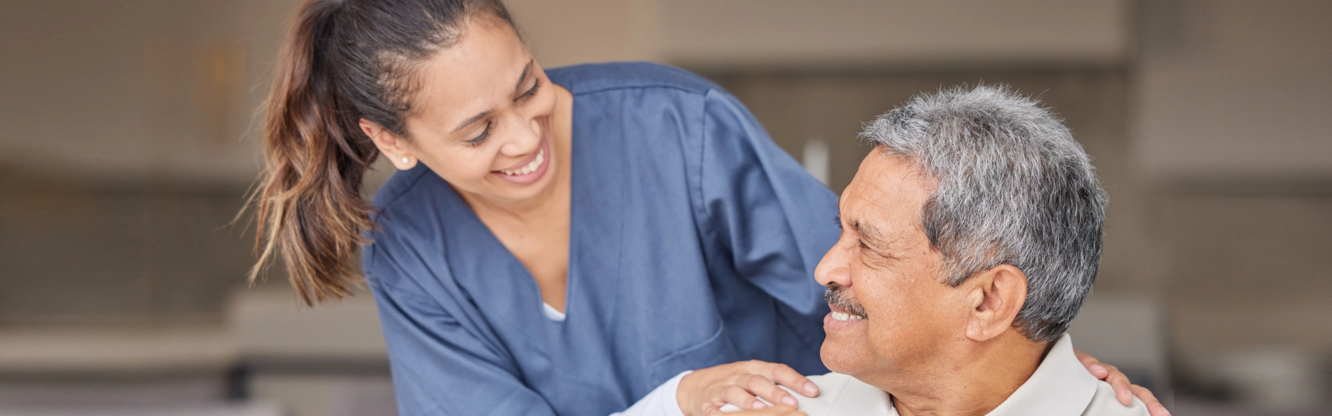 female caregiver smiling at an elderly man