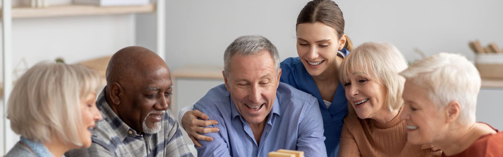 Group of elderly with the nurse playing games