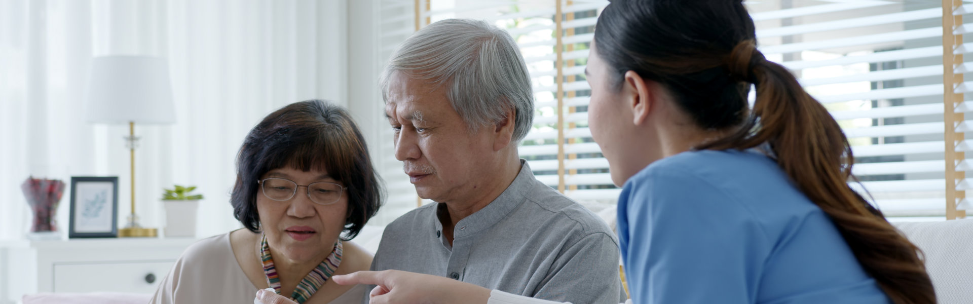 Elderly Couple look at the prescription giving of the nurse