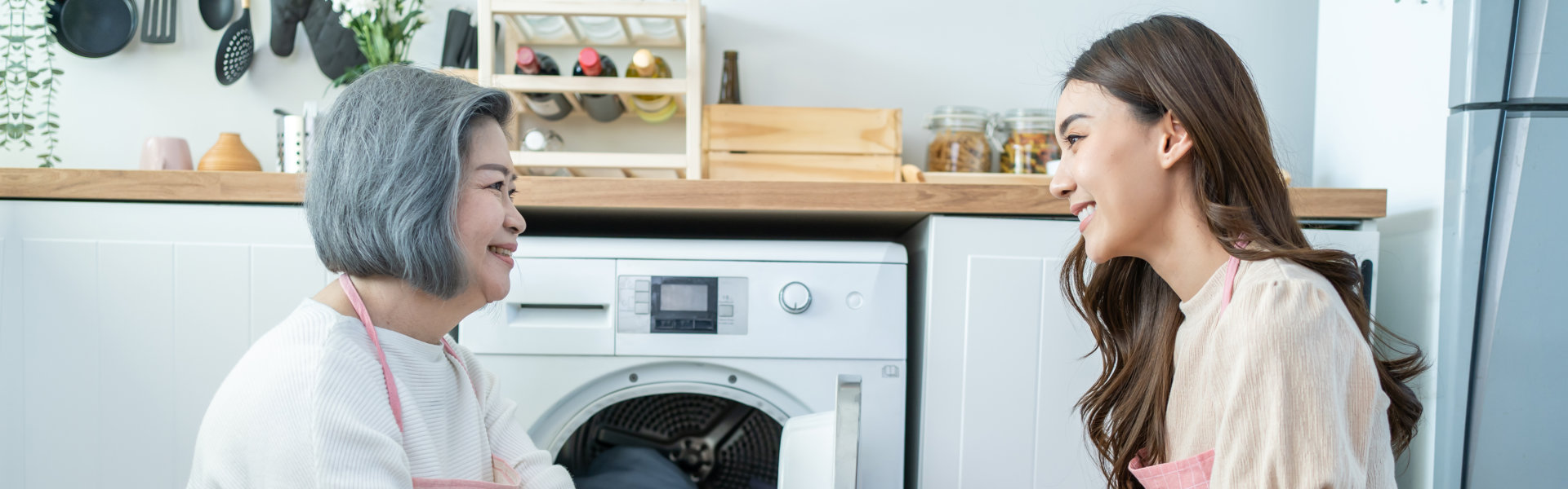 Elder woman and the young beautiful woman are doing laundry